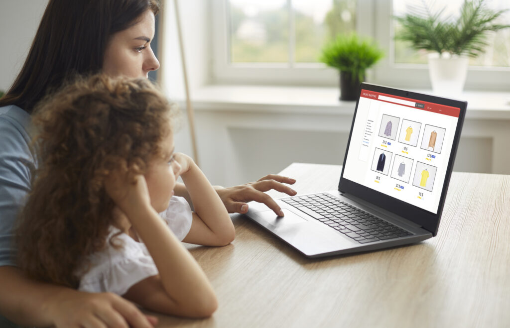 Mother and child shopping for new clothes for school online